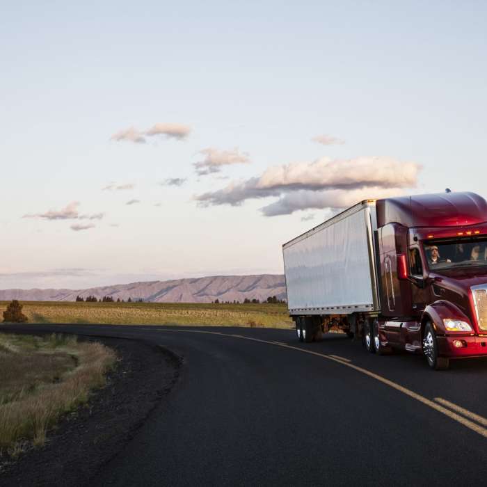 truck on a highway through the grasslands area of eastern Washington, USA.